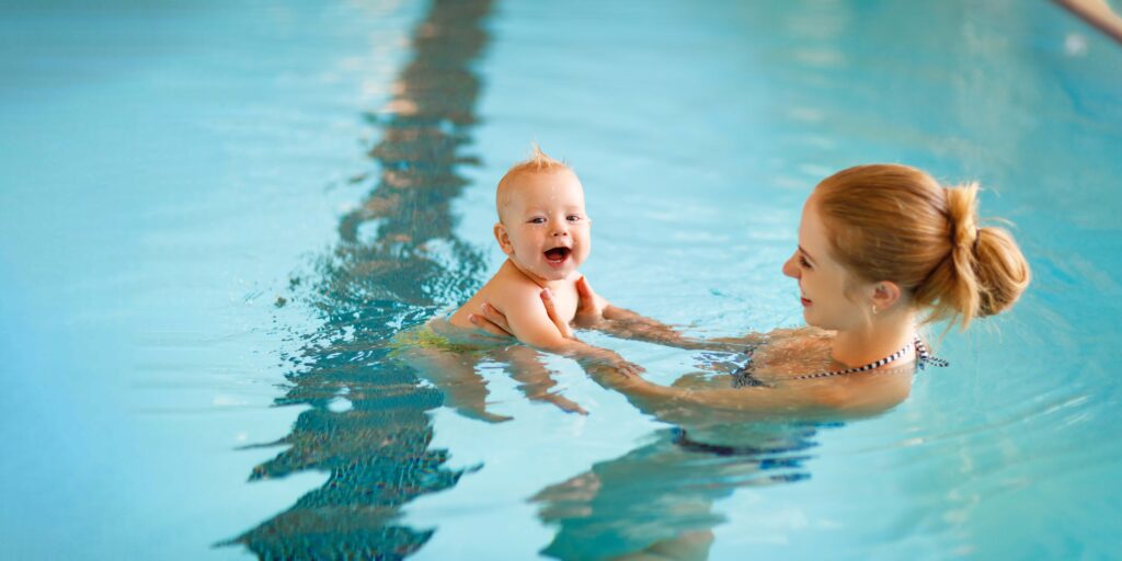 Mother and baby swim in the pool