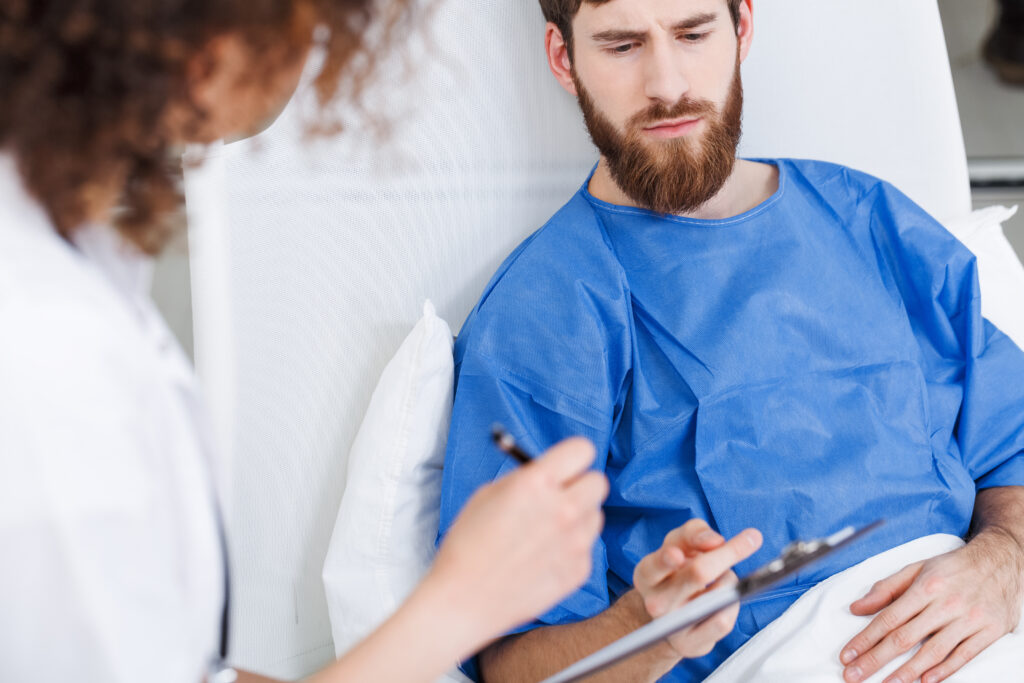 Psychiatric doctor diagnosing young man's mental health problems