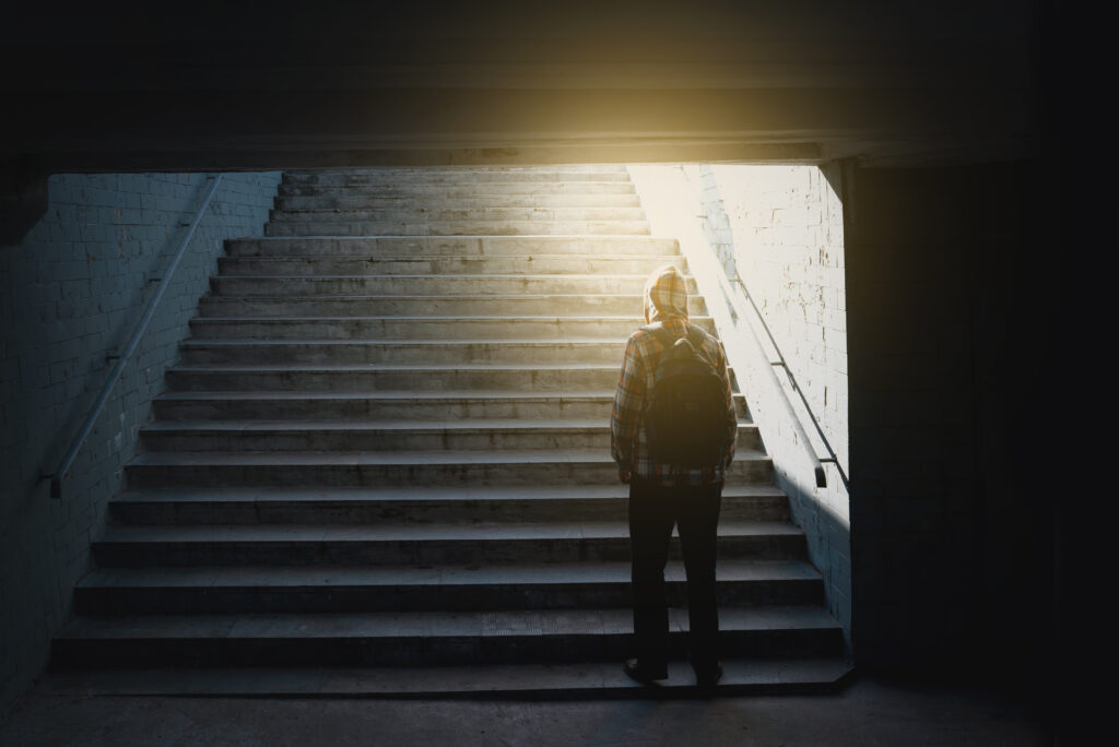 Loneliness man standing back in subway underground crossing