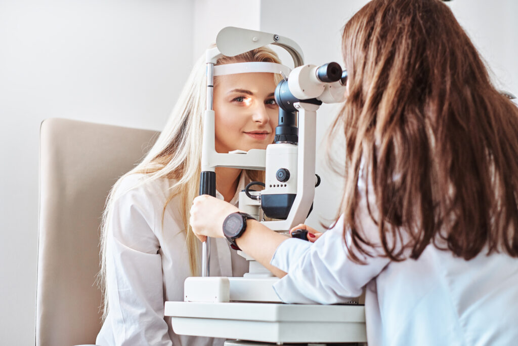 Woman is doing eye test in optical clinic with experienced oculist.